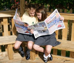 Kids reading news paper